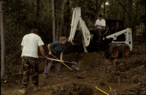 Bobcat and shovels used to strip plowzone.