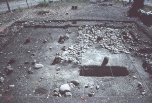View of House 16, taken from the south. The marl floor, cobble floor, and yard burial are visible in this photograph.