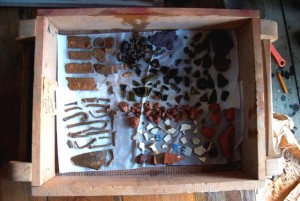 Drying washed artifacts from a shovel test pit in Area 1. Photographed by Hayden Bassett, June 2014.