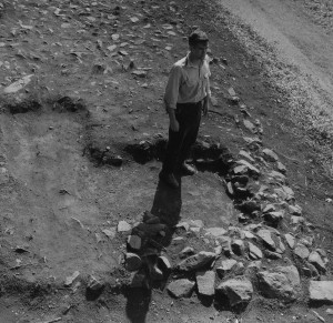 Man standing in Pi-Sunyer's test unit into the cobble pavement of Building D.